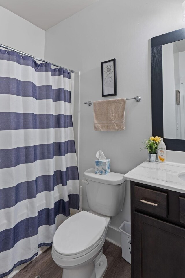 7587 Highborne Ln, Ooltewah, TN 37363 - bathroom featuring vanity, wood finished floors, toilet, and a shower with curtain