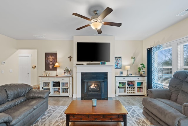 7587 Highborne Ln, Ooltewah, TN 37363 - living area with wood finished floors, ceiling fan, and a warm lit fireplace