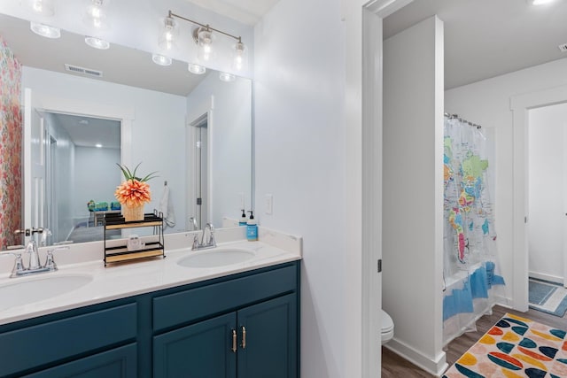 7587 Highborne Ln, Ooltewah, TN 37363 - full bath featuring wood finished floors, double vanity, toilet, shower / tub combo, and baseboards