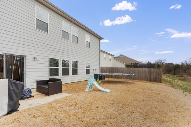 7587 Highborne Ln, Ooltewah, TN 37363 - back of property with a trampoline and central air condition unit