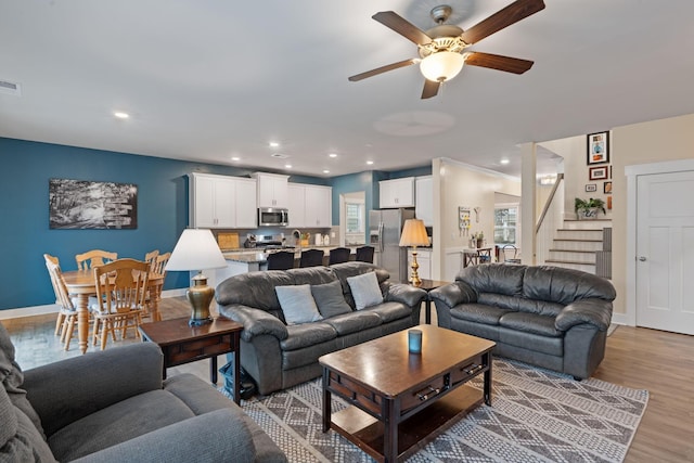 7587 Highborne Ln, Ooltewah, TN 37363 - living area featuring stairway, a ceiling fan, recessed lighting, light wood-style floors, and baseboards