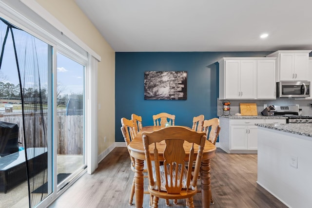 7587 Highborne Ln, Ooltewah, TN 37363 - dining area featuring light wood-style flooring, recessed lighting, and baseboards