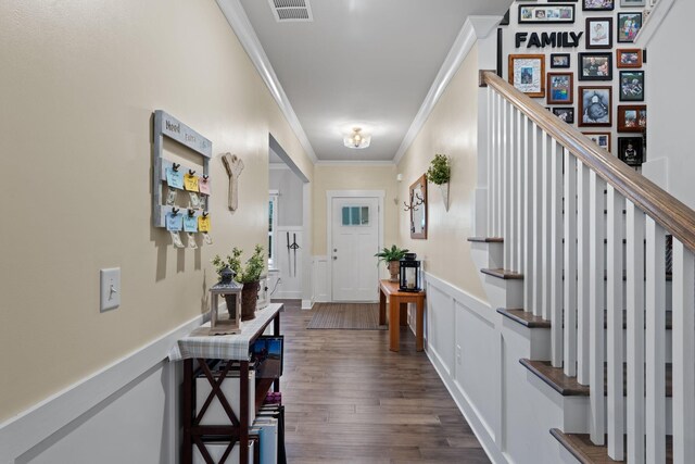 7587 Highborne Ln, Ooltewah, TN 37363 - foyer entrance with ornamental molding, a wainscoted wall, dark wood finished floors, stairs, and a decorative wall