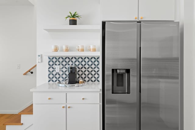 121 Old Mountain Rd, Chattanooga, TN 37409 - kitchen with stainless steel refrigerator with ice dispenser, open shelves, light countertops, wood finished floors, and white cabinets