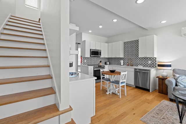 121 Old Mountain Rd, Chattanooga, TN 37409 - kitchen with stainless steel appliances, backsplash, white cabinetry, light countertops, and recessed lighting