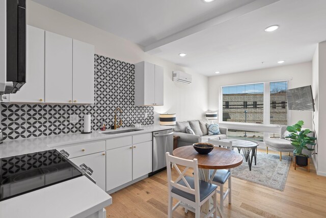 121 Old Mountain Rd, Chattanooga, TN 37409 - kitchen featuring stainless steel dishwasher, a wall mounted air conditioner, a sink, light countertops, and tasteful backsplash