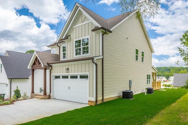 5008 Swan Rd, Chattanooga, TN 37416 - view of side of property with board and batten siding, a garage, concrete driveway, and a yard