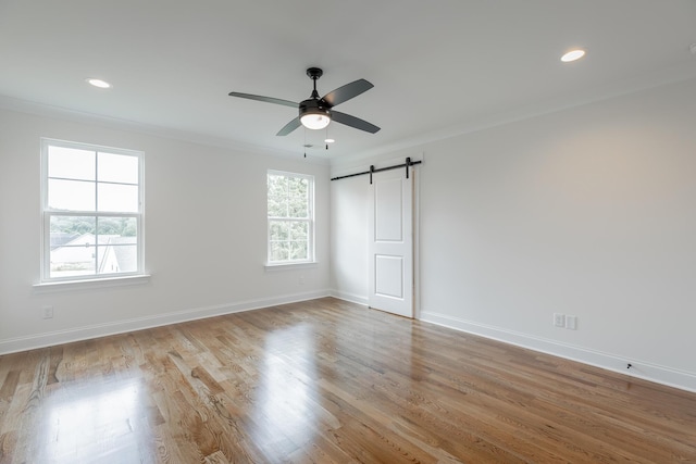 5008 Swan Rd, Chattanooga, TN 37416 - unfurnished room with a barn door, a ceiling fan, recessed lighting, wood finished floors, and crown molding