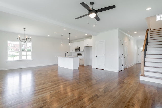 5008 Swan Rd, Chattanooga, TN 37416 - unfurnished living room featuring stairway, recessed lighting, ornamental molding, a chandelier, and dark wood-style floors