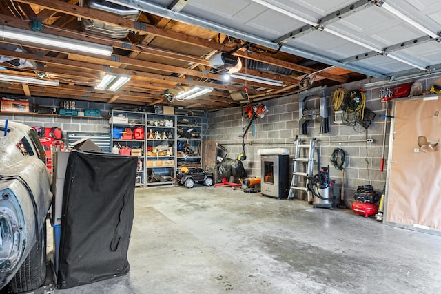 garage with concrete block wall and a garage door opener