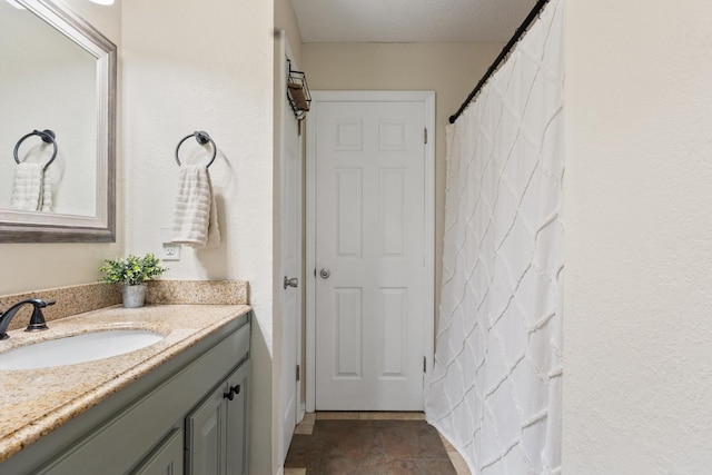 full bathroom with vanity and stone finish flooring