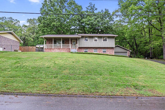 tri-level home with covered porch and brick siding