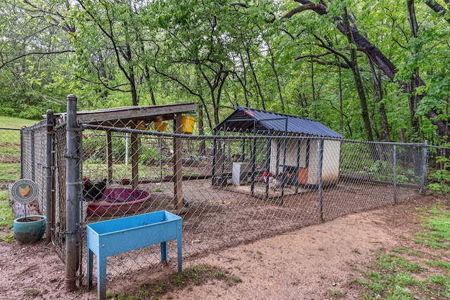 view of property's community featuring exterior structure, an outbuilding, and fence