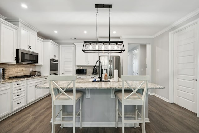 122 Blake Ln, Mount Juliet, TN 37122 - kitchen with appliances with stainless steel finishes, backsplash, crown molding, white cabinetry, and a center island with sink