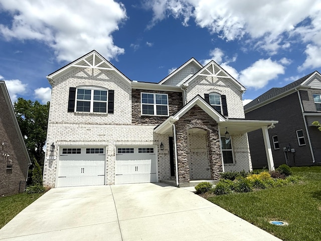 122 Blake Ln, Mount Juliet, TN 37122 - view of front of house featuring concrete driveway, a garage, stone siding, brick siding, and a front lawn
