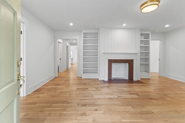215 Lewisburg Ave, Franklin, TN 37064 - unfurnished living room with built in features, light wood-type flooring, baseboards, recessed lighting, and a fireplace