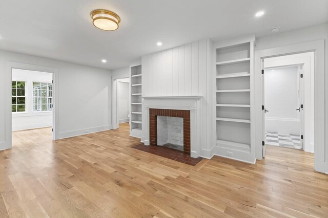 215 Lewisburg Ave, Franklin, TN 37064 - unfurnished living room featuring light wood finished floors, built in features, a fireplace, baseboards, and recessed lighting
