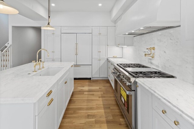 215 Lewisburg Ave, Franklin, TN 37064 - kitchen with a sink, custom exhaust hood, high quality appliances, light wood-type flooring, and white cabinets