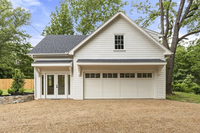 215 Lewisburg Ave, Franklin, TN 37064 - view of front facade with french doors, a garage, fence, and a shingled roof