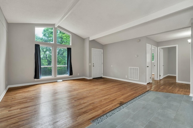 spare room with wood finished floors and baseboards