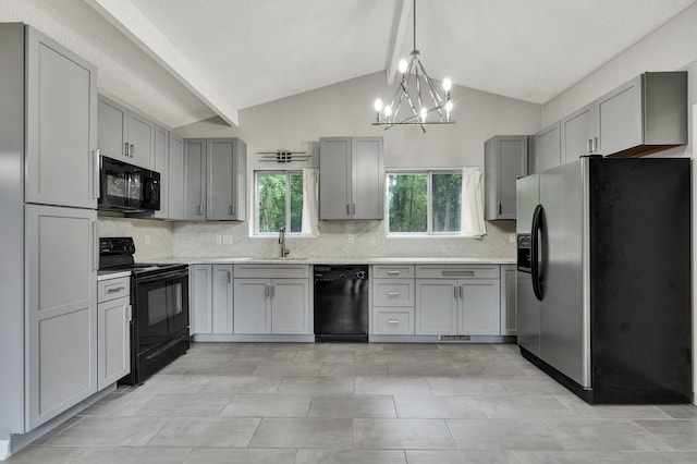 kitchen with black appliances, gray cabinets, a sink, and decorative backsplash