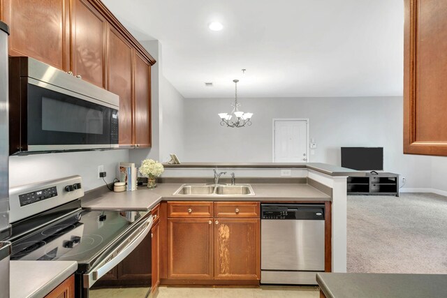 7230 Althorp Way Unit W 12, Nashville, TN 37211 - kitchen with stainless steel appliances, a sink, a peninsula, a chandelier, and open floor plan