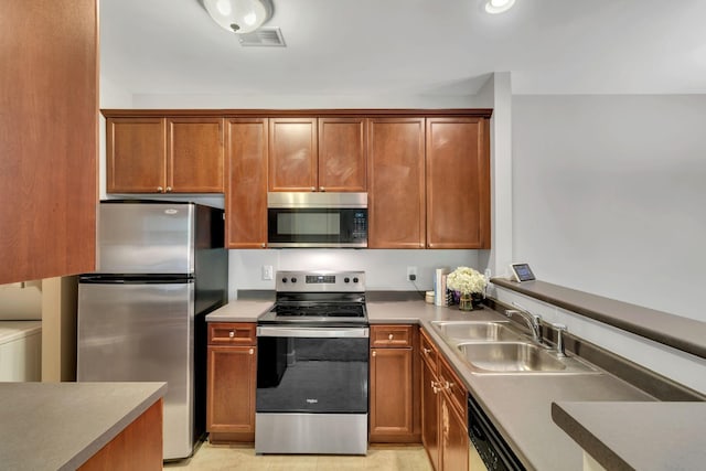 7230 Althorp Way Unit W 12, Nashville, TN 37211 - kitchen featuring stainless steel appliances, a sink, and brown cabinets