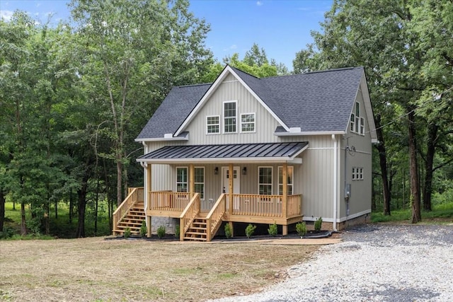 1014 Promise Land Rd, Charlotte, TN 37036 - view of front facade featuring covered porch, a standing seam roof, stairway, and roof with shingles