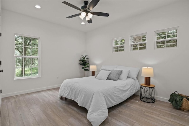 1014 Promise Land Rd, Charlotte, TN 37036 - bedroom with wood finished floors, multiple windows, recessed lighting, and a ceiling fan