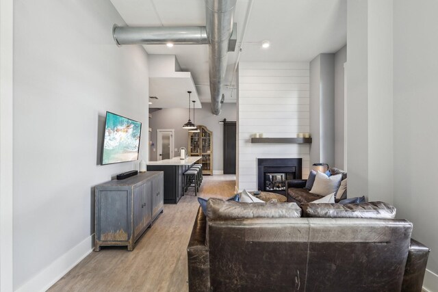 205 31st Ave N Unit 111, Nashville, TN 37203 - living room with a fireplace, light wood finished floors, and baseboards