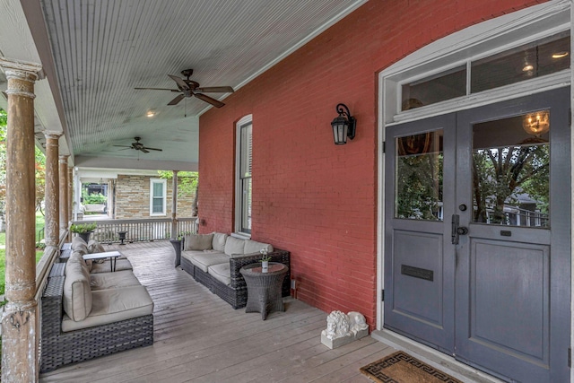wooden deck with ceiling fan, a porch, and french doors