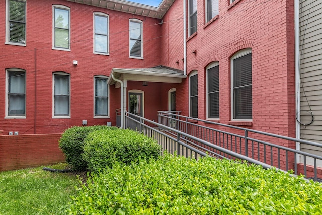 doorway to property featuring brick siding