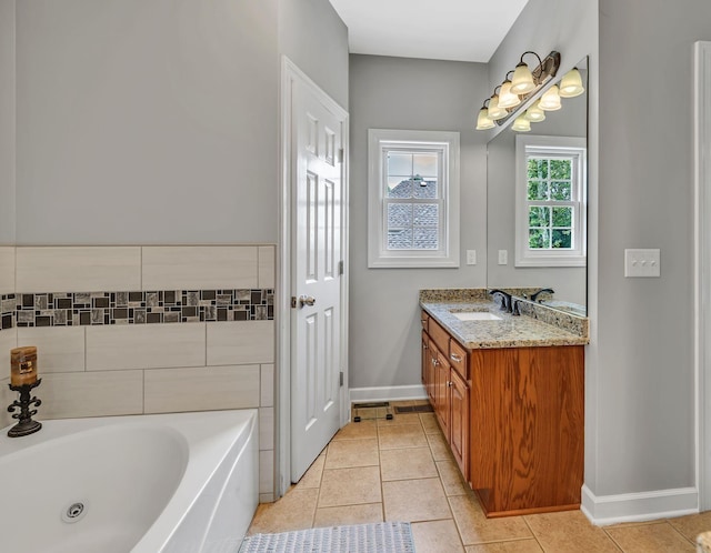 212 Spirit Hill Cir, Smyrna, TN 37167 - bathroom with tile patterned floors, a bathtub, vanity, and baseboards