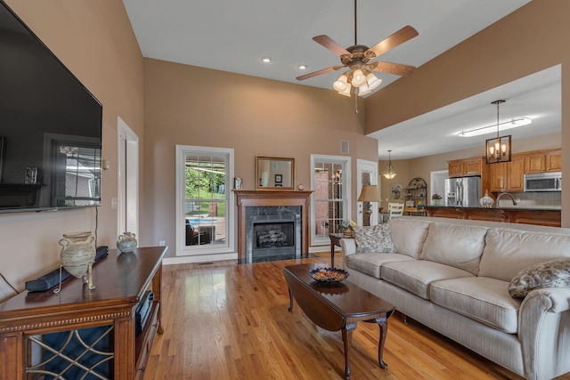 212 Spirit Hill Cir, Smyrna, TN 37167 - living area with a high ceiling, light wood finished floors, a ceiling fan, a fireplace, and recessed lighting