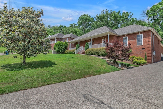 212 Spirit Hill Cir, Smyrna, TN 37167 - single story home with brick siding, a front yard, a porch, and roof with shingles
