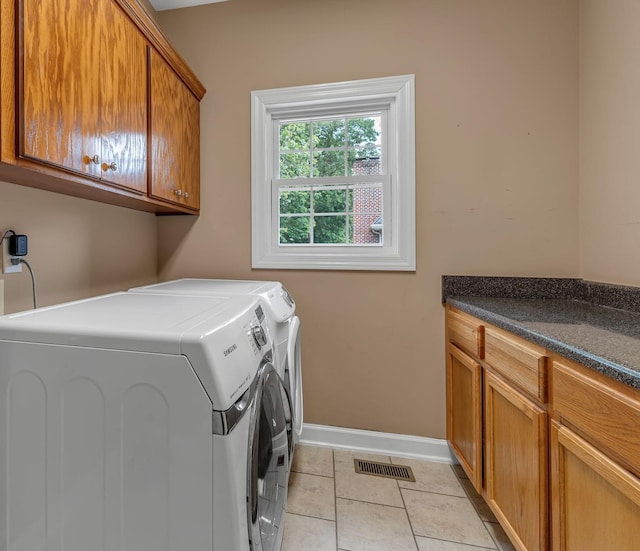 212 Spirit Hill Cir, Smyrna, TN 37167 - laundry room featuring washing machine and clothes dryer, cabinet space, baseboards, and light tile patterned floors