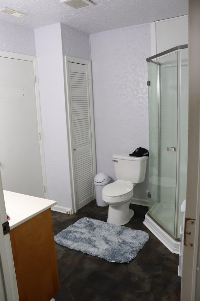 261 Oak Dr, Beechgrove, TN 37018 - full bathroom with a closet, toilet, vanity, a shower stall, and a textured ceiling