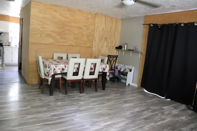 261 Oak Dr, Beechgrove, TN 37018 - dining room featuring wood finished floors, a textured ceiling, and wood walls
