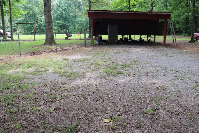 261 Oak Dr, Beechgrove, TN 37018 - view of yard with a detached carport, a pole building, a view of trees, and an outbuilding