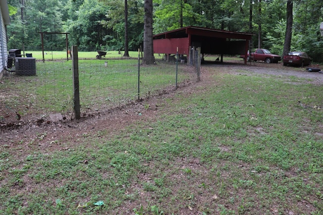 261 Oak Dr, Beechgrove, TN 37018 - view of yard featuring a wooded view, a carport, a pole building, and cooling unit