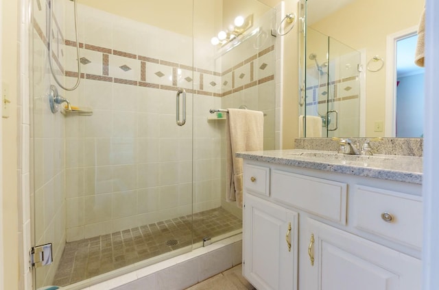 bathroom with a stall shower and vanity