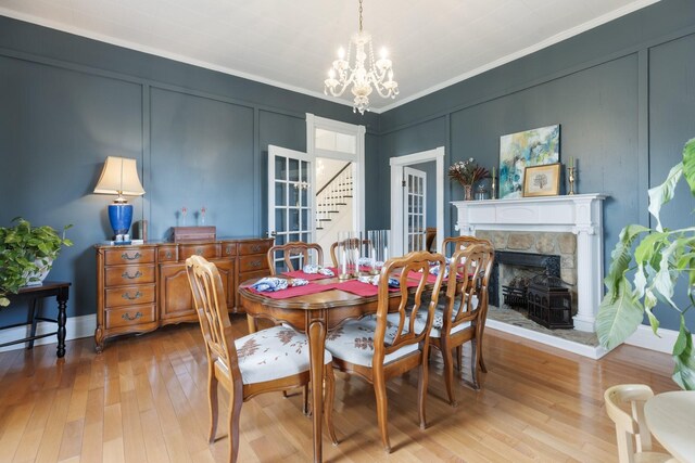 3310 Booker Ridge Rd, Mount Pleasant, TN 38474 - dining space featuring a decorative wall, a chandelier, light wood-type flooring, ornamental molding, and stairs