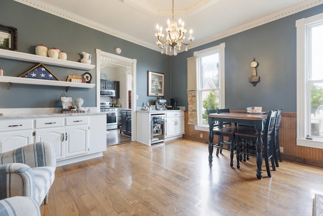 3310 Booker Ridge Rd, Mount Pleasant, TN 38474 - dining space featuring wine cooler, a chandelier, light wood-style floors, ornamental molding, and a wainscoted wall