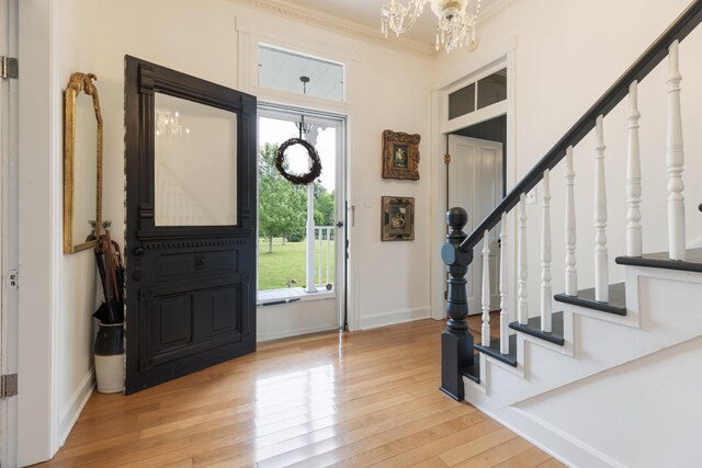3310 Booker Ridge Rd, Mount Pleasant, TN 38474 - entryway with stairs, wood finished floors, a chandelier, baseboards, and crown molding