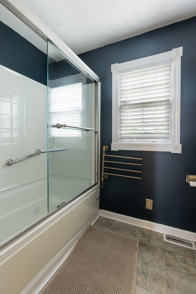 3310 Booker Ridge Rd, Mount Pleasant, TN 38474 - full bath featuring bath / shower combo with glass door, baseboards, and a textured ceiling