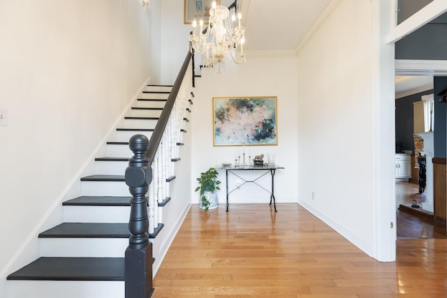 3310 Booker Ridge Rd, Mount Pleasant, TN 38474 - stairway featuring wood finished floors, a chandelier, a high ceiling, crown molding, and baseboards