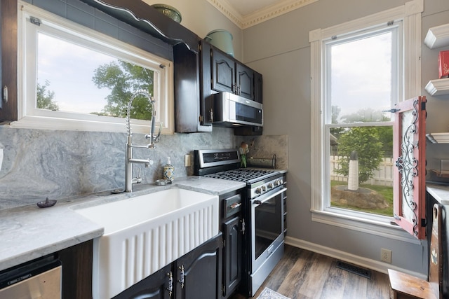 3310 Booker Ridge Rd, Mount Pleasant, TN 38474 - kitchen with stainless steel appliances, dark wood-style floors, decorative backsplash, healthy amount of natural light, and crown molding