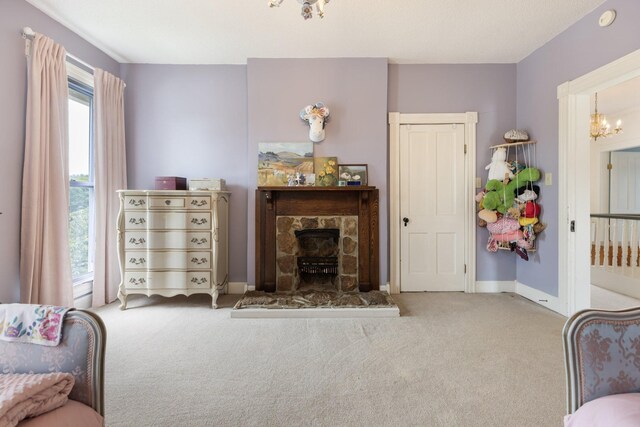 3310 Booker Ridge Rd, Mount Pleasant, TN 38474 - carpeted living area with a stone fireplace, baseboards, and a chandelier