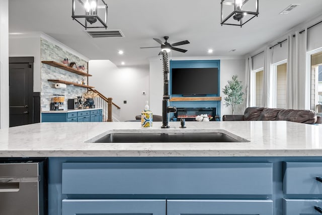kitchen featuring open floor plan, blue cabinets, light stone counters, and recessed lighting