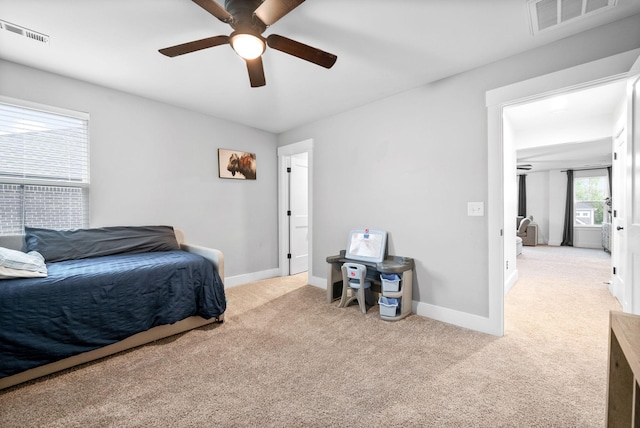 carpeted bedroom with baseboards and a ceiling fan